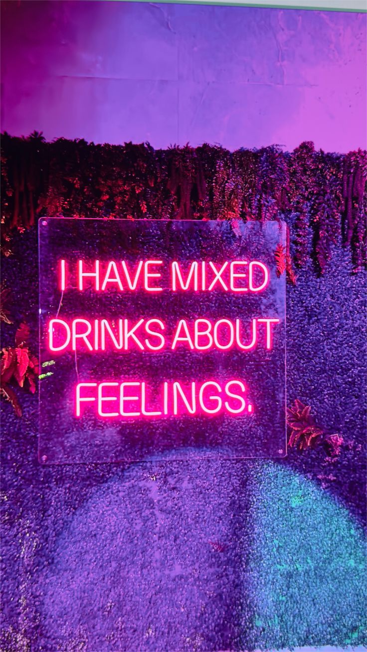 A vibrant 30” x 30” pink neon sign reading "I Have Mixed Drinks About Feelings," mounted on an acrylic backing with a glowing ambiance, perfect for bars and lounges.