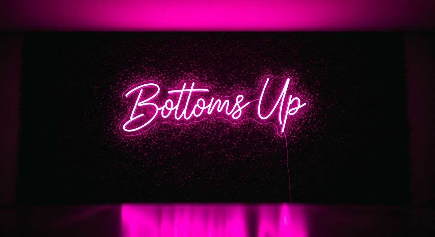 Bottoms Up Neon Sign - pink neon on grass background