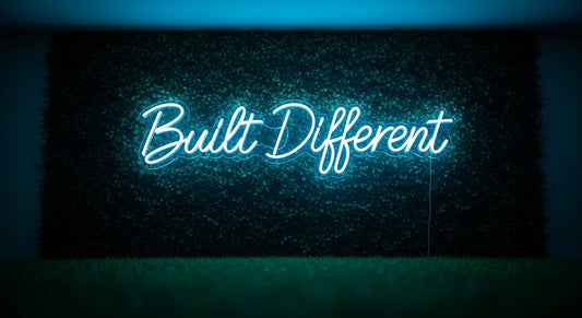 Built Different Neon Sign - ice blue neon on grass background
