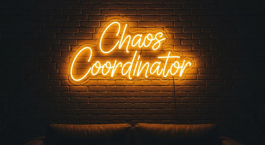 Chaos Coordinator Neon Sign - yellow neon on brick background