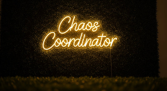 Chaos Coordinator Neon Sign - yellow neon on grass background