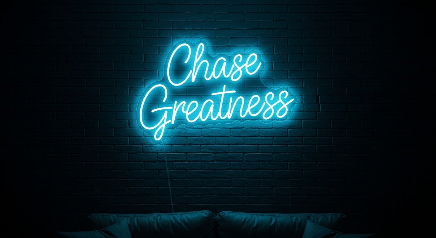 Chase Greatness neon sign in ice blue on brick wall