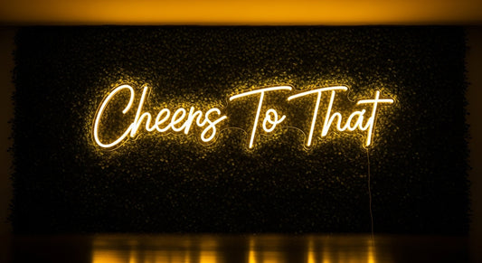 Cheers To That Neon Sign - yellow neon on grass background