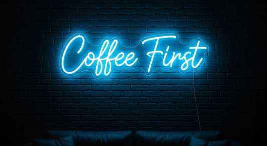 Coffee First Neon Sign - ice blue neon on brick background