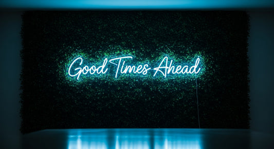 Good Times Ahead Neon Sign - ice blue neon on grass background
