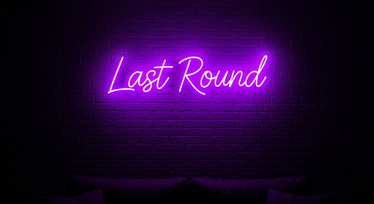 Last Round Neon Sign - purple neon on brick background
