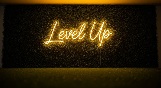 Level Up Neon Sign - yellow neon on grass background