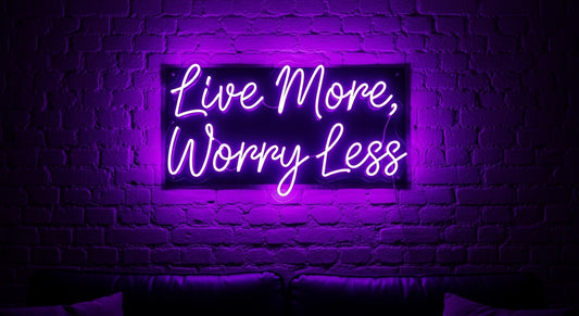 Live More, Worry Less neon sign in purple