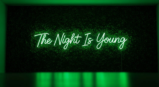 The Night Is Young Neon Sign - green neon on grass background
